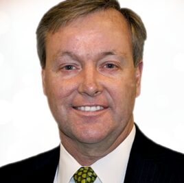 Head-shot of a middle-aged Caucasian man with short brown hair in a suit and tie